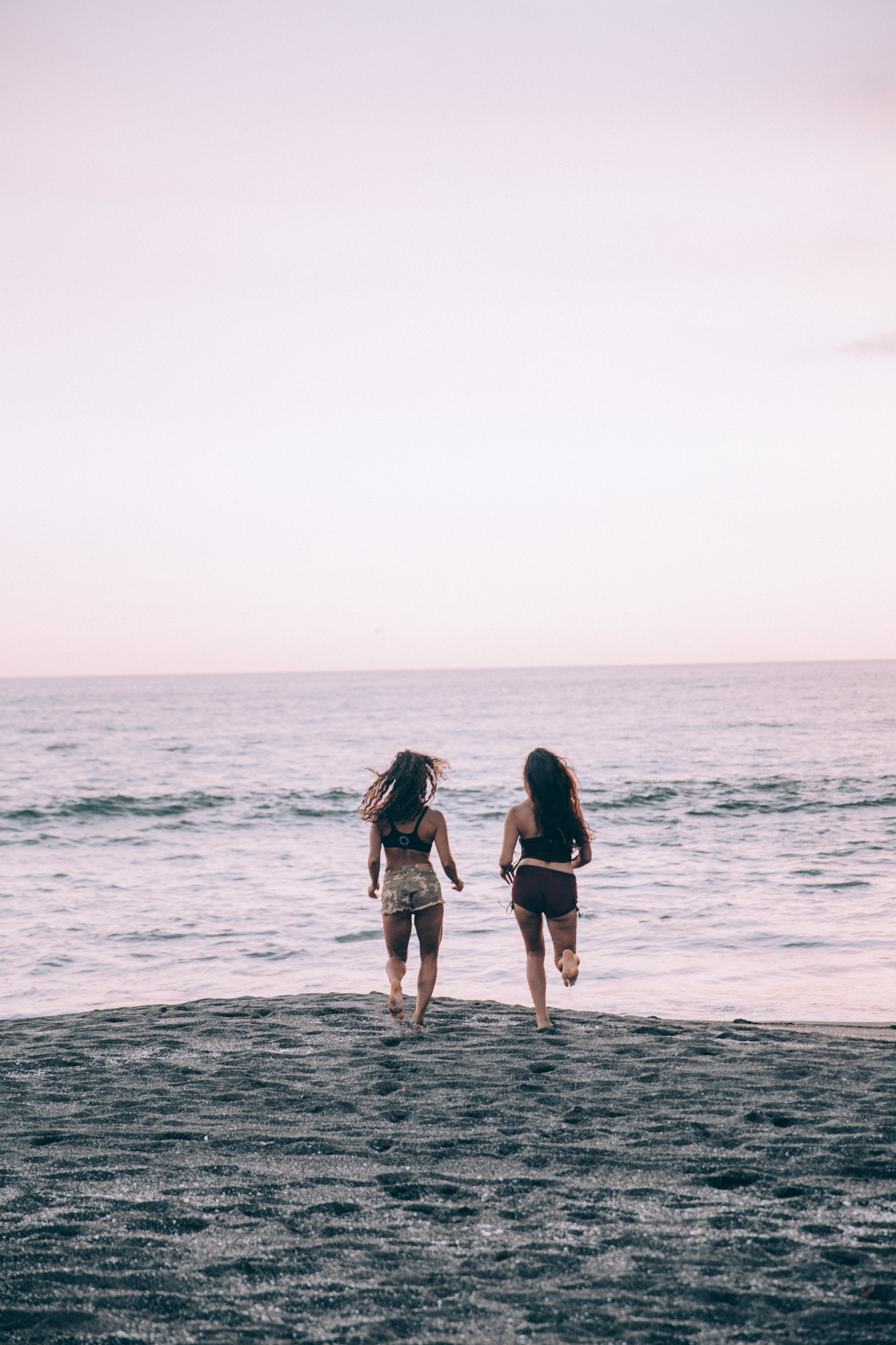 two-women-run-along-a-sunset-beach.jpg